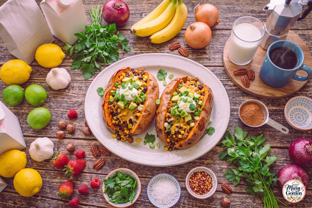 Easy turkey stuffed sweet potatoes topped with cheddar, avocado, cilantro, and green onions