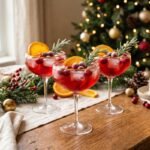 Festive Christmas mocktail with cranberry juice, orange slices, cranberries, and rosemary